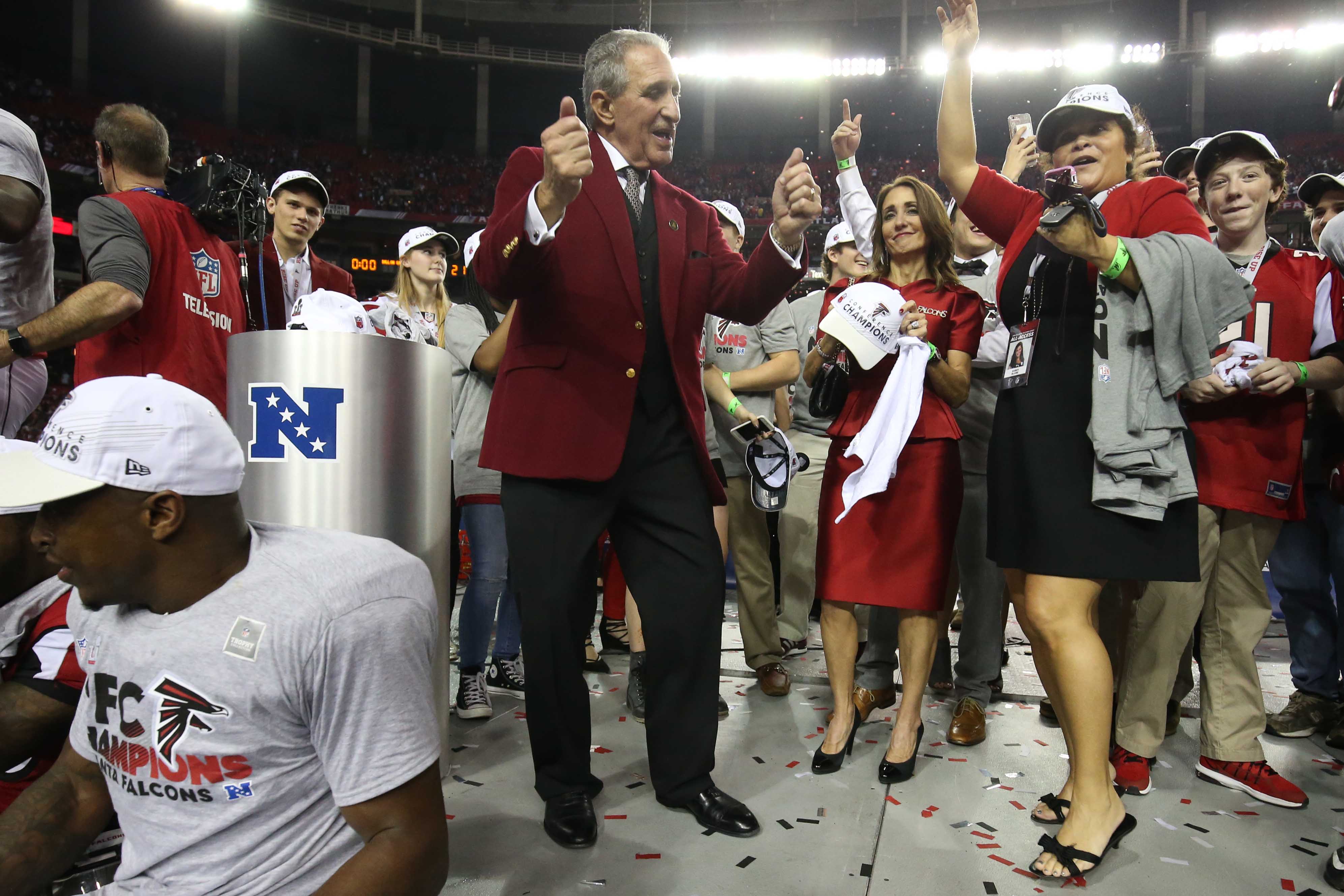 Atlanta Falcons owner Arthur Blank (L) dances with players after defeating  the Green Bay Packers 44-21 to win the NFC Championship game at the Georgia  Dome on January 22, 2017 in Atlanta.